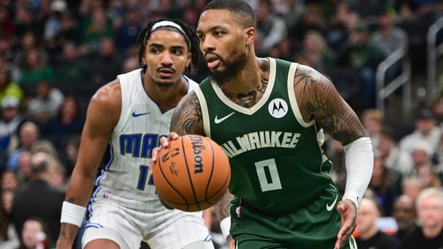 Milwaukee Bucks guard Damian Lillard (0) drives past Orlando Magic guard Gary Harris (14) 